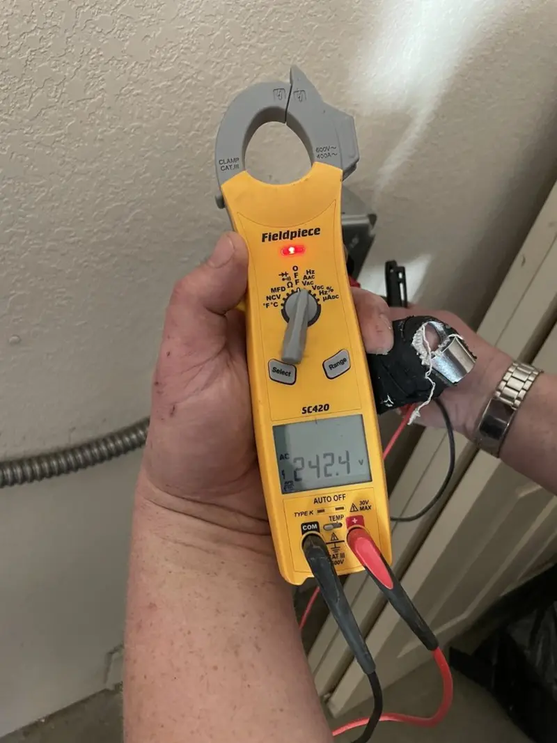 Voltage testing with clamp meter during Recessed Lighting Installation in Smithville